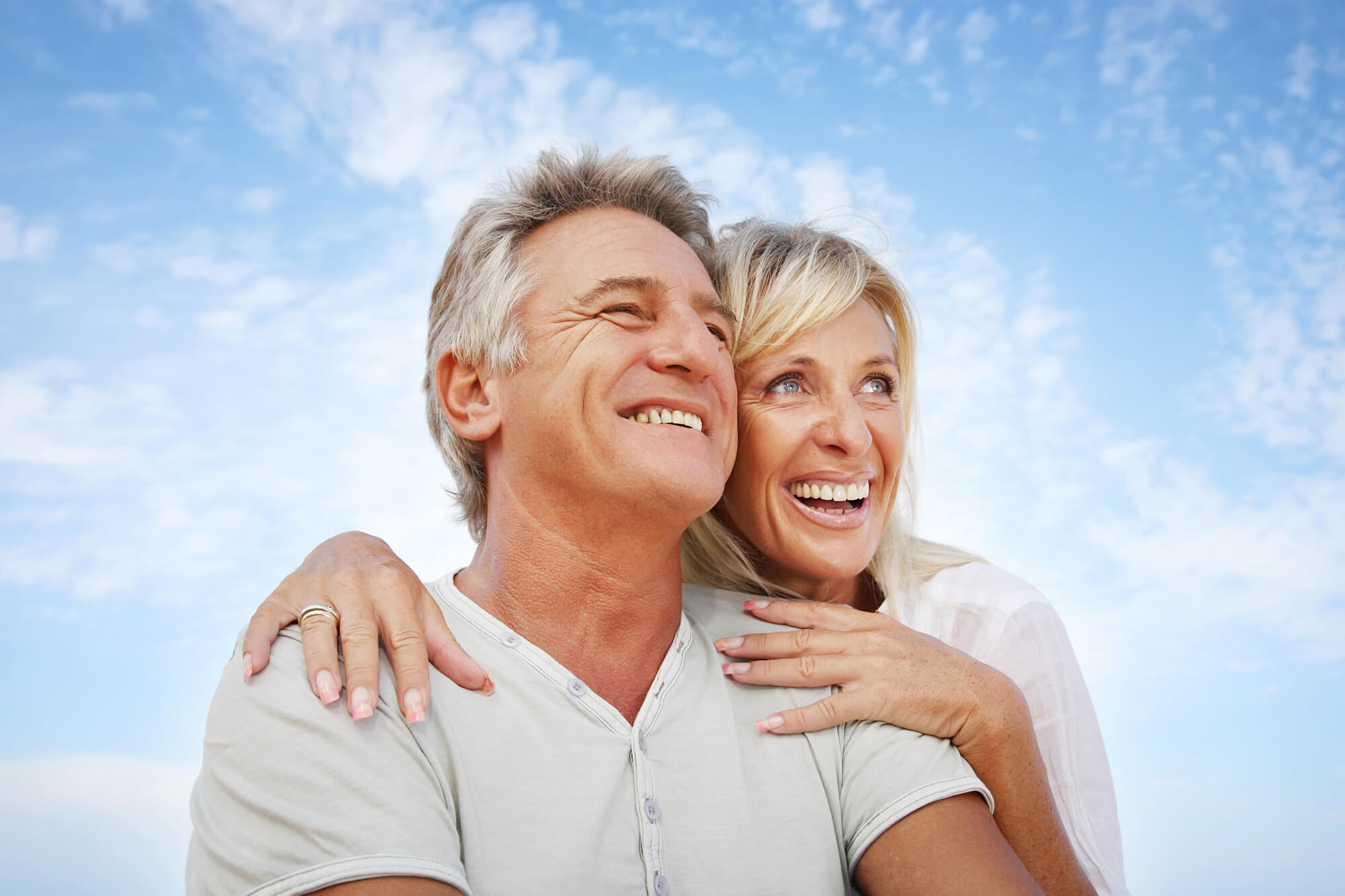 older couple wearing Treasure Coast Dentures and smiling