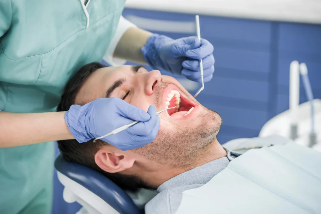 Patient receiving dental checkup with tools dentist in Fort Pierce
