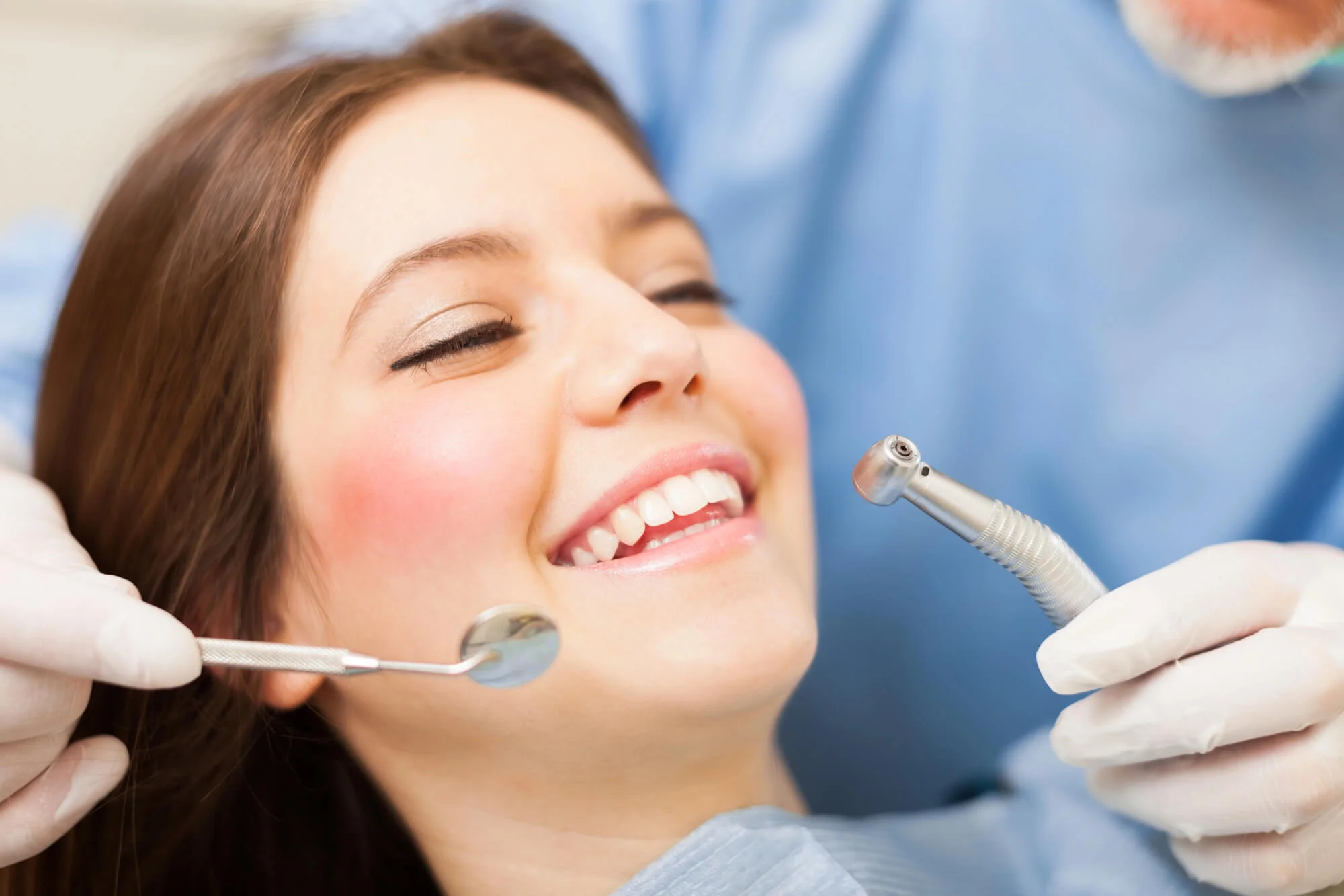 Smiling woman during dental checkup, dentist in Indian River