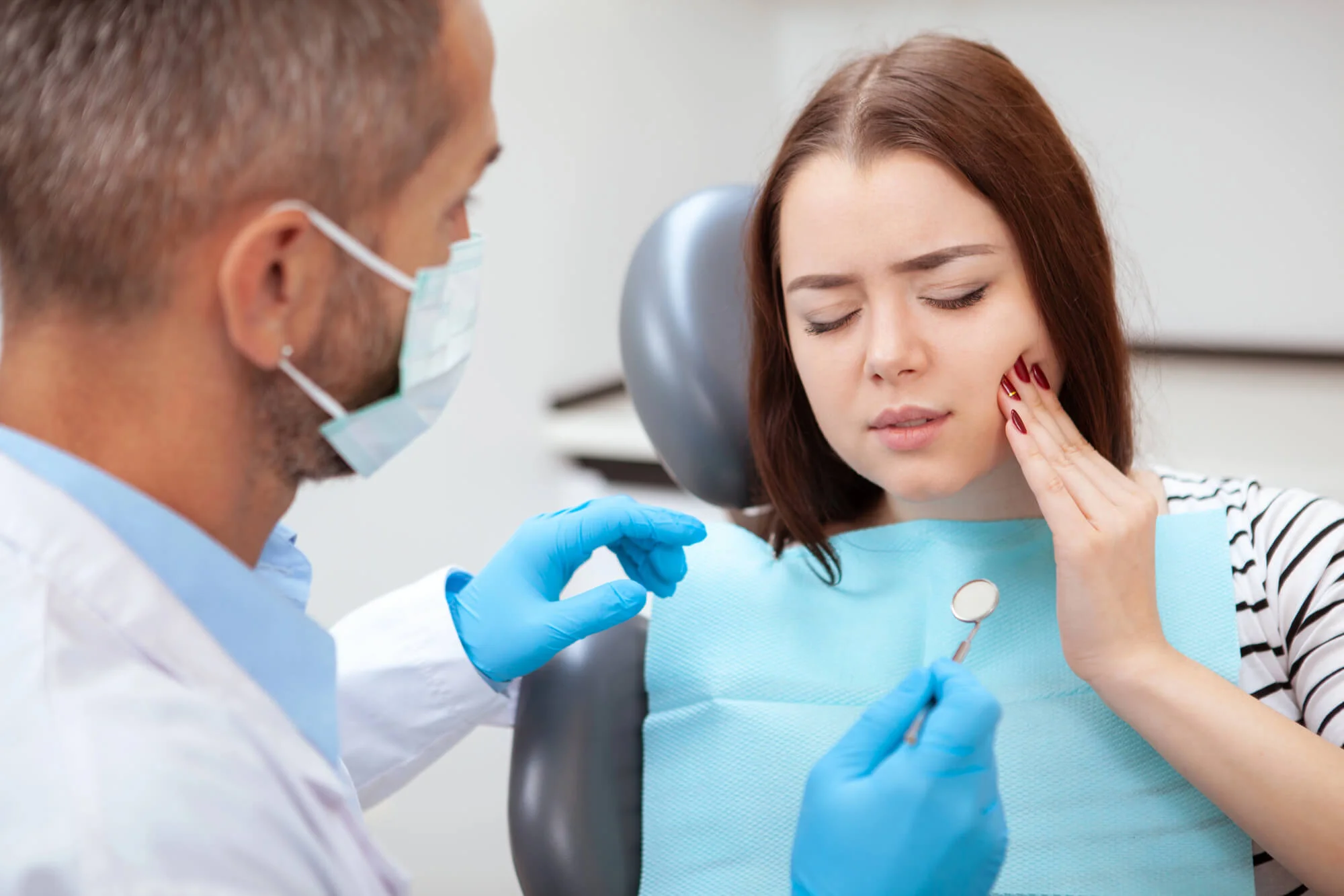 Woman with toothache at dental visit best dentist in Fort Pierce