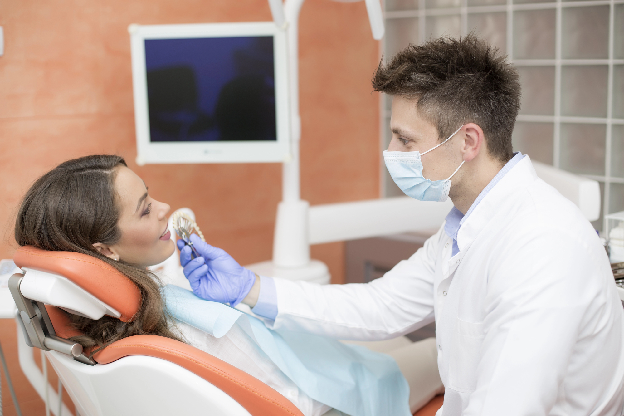 Dentist checking the girls teeth with Dental Implants Fort Pierce