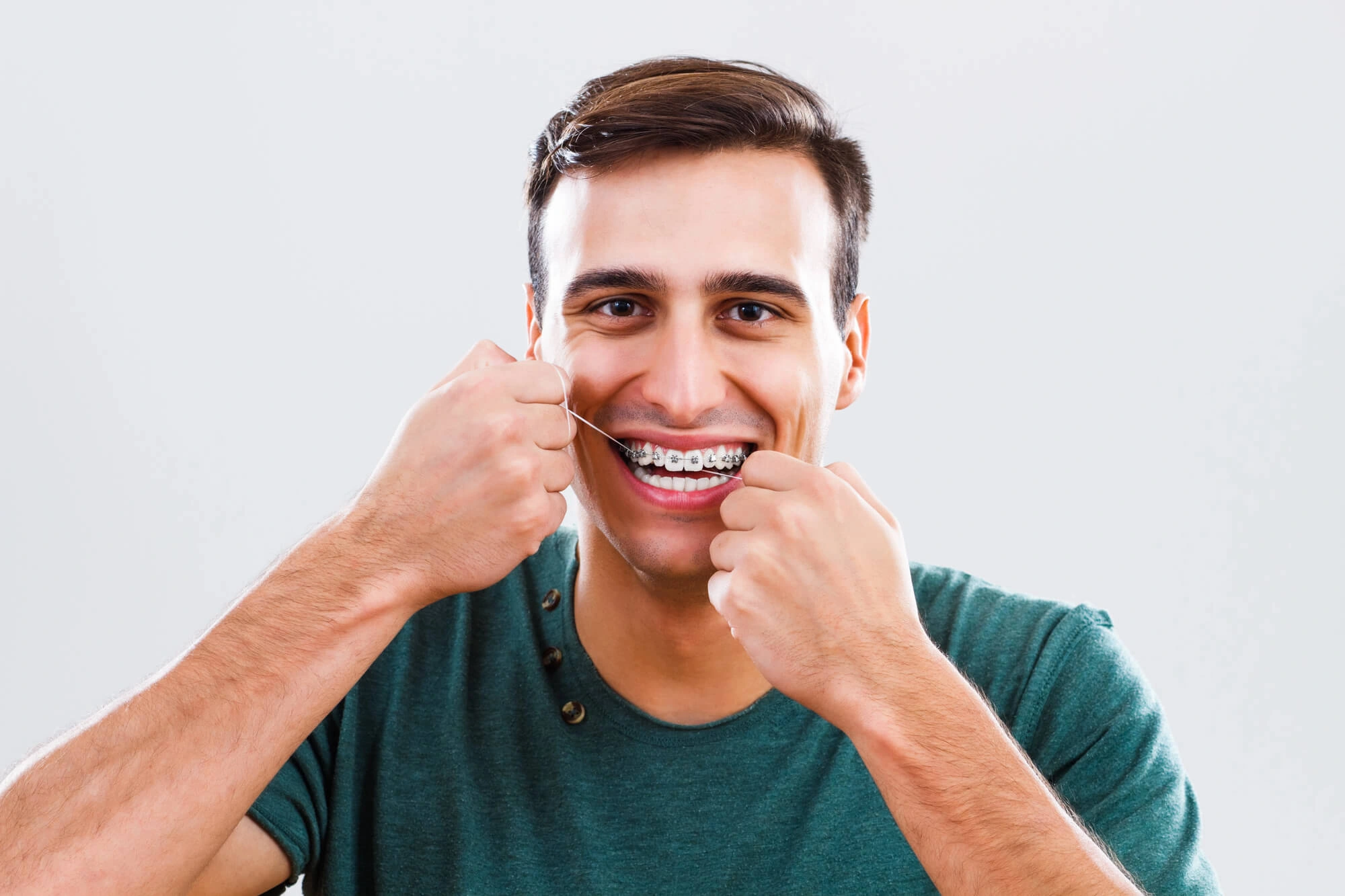 Man flossing his Fort Pierce Dentures